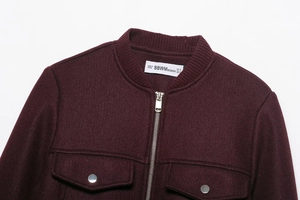 Detail of burgundy wool jacket collar and zipper with high-quality fabric texture