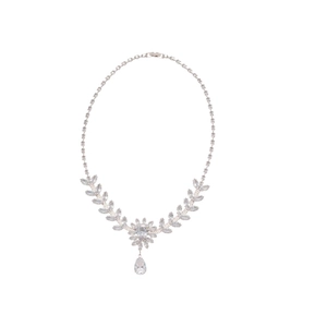 Sparkling zircon leaf and flower pendant necklace with teardrop crystal on white backdrop