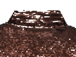 Close-up of brown sequins on fabric showing detailed metallic texture and stitching