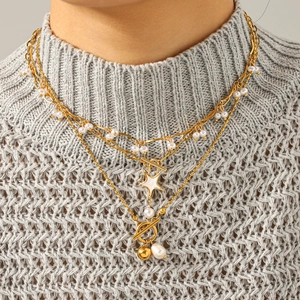 Double-layered gold pearl necklace with star pendant and OT buckle on model neck
