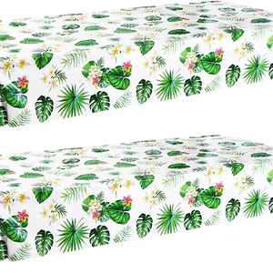 Tropical Hawaiian party tablecloth set with flamingos, palm leaves, and plumeria flowers