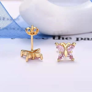 Macro shot of butterfly earrings in s925 silver with pink stones and gold plating