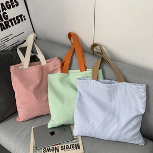 Three striped canvas tote bags in red, blue, and green for stylish daily commuting