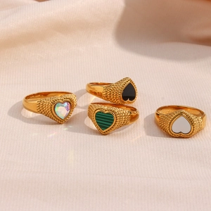 Detail of four 18K gold plated twisted band rings with colorful heart shaped zircons