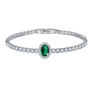 Detail of tennis bracelet featuring oval green emerald and silver cubic zirconia stones