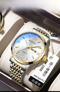 Detail of men's two-tone quartz watch with white dial, date display and steel bracelet
