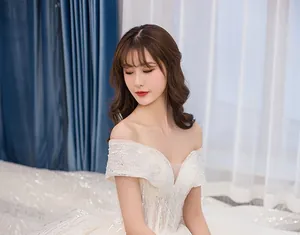 Detailed view of luxury off-the-shoulder wedding gown with hand-beaded sequins and embroidery