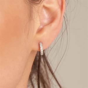 Close-up of S925 sterling silver geometric huggie earrings with cubic zirconia stones