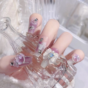 Handmade purple galaxy press-on nails with 3D floral accents and rhinestones
