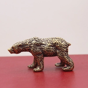 Macro detail of the antique brass polar bear ornament showing realistic fur texture