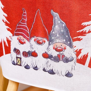 Detailed close-up of a Christmas chair cover featuring cute gnomes and linen texture
