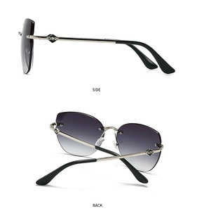 Detail view of rimless cat-eye sunglasses with gradient lenses and silver metal temples