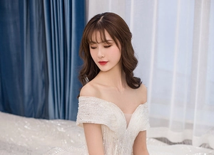 Detailed view of off-the-shoulder wedding dress with silver sequins and beadwork embroidery