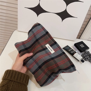 Classic British plaid cosmetic bag with simple wish label held in a lifestyle setting