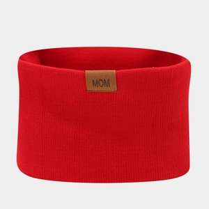 Detailed knit texture of red neck warmer with MOM faux leather patch for winter
