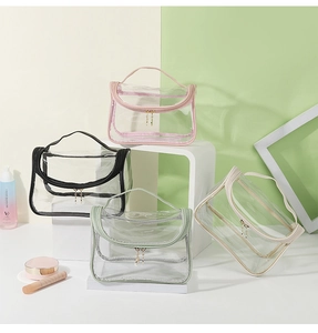 Detail view of four colorful transparent waterproof travel toiletry bags with handles