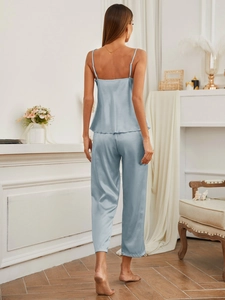 Light blue satin pajama set detail showing wavy hem on camisole and back view fit