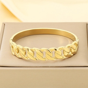 Elegant gold-plated stainless steel curb link bangle bracelet on jewelry display