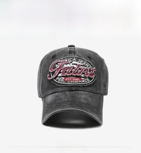 Detailed front view of vintage dark gray washed cotton baseball cap with oval embroidery