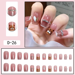 Pink gradient press-on nails with tiger cartoon patterns and sparkling rhinestones