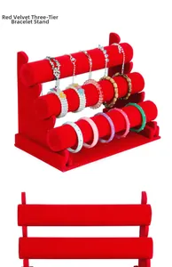 Detail view of red velvet three-tier jewelry display stand for bracelets and watches