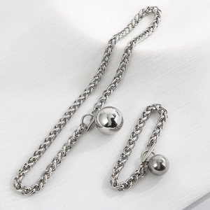 Macro shot of polished silver keel chain set with smooth metal ball pendants
