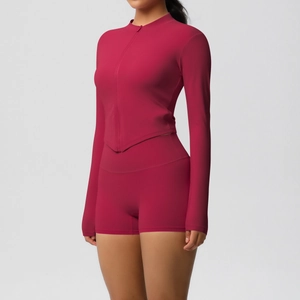 Detail of slim fit long sleeve yoga jacket and high waist shorts in deep red fabric