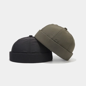 Waterproof quick-dry docker hat in black and olive green, stack view with rolled brim