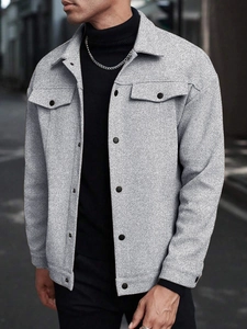 Detail of grey marl men's jacket with lapels, flap pockets and premium fabric texture