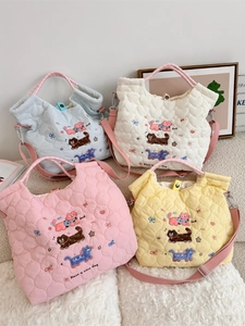 Detailed view of quilted tote bags in four soft colors with cute cartoon cat embroidery