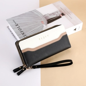 Detailed macro view of a large capacity color-block long wallet with double zipper
