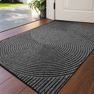 Close-up of grey anti-slip entryway mat with circular woven texture on a wooden floor