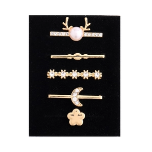 Close-up of five-piece golden alloy decorative rings with pearls and rhinestones