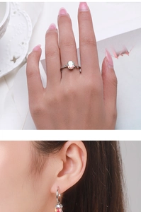 Detail view of model wearing S925 sterling silver ring and earrings with rainbow gemstones