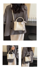 Detail of white lychee textured bucket bag with silk scarf and adjustable strap