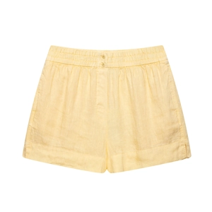 Detail of light yellow linen shorts featuring an elastic waist and decorative buttons