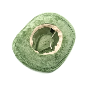 Detail view of the green plush cowboy hat interior with adjustable size drawstring