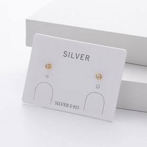 Macro shot of S925 sterling silver round cubic zirconia stud earrings in gold plating
