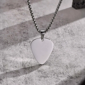 Polished stainless steel guitar pick pendant necklace on a silver ball chain with stone background