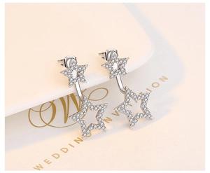 Macro shot of S925 sterling silver star earrings with white cubic zirconia inlay