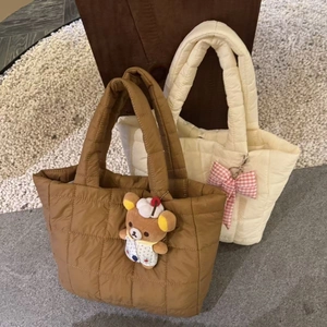 Quilted caramel and beige tote bags with plush bear charm and bow decoration