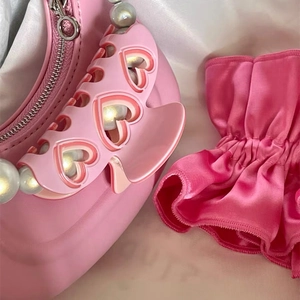 Pink heart-shaped handle handbag with pearl details and smooth leather texture