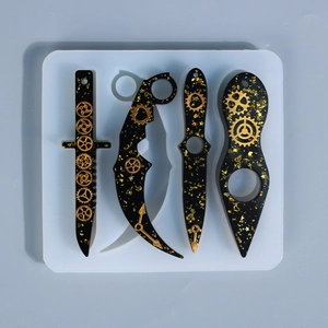 Macro detail of DIY silicone mold with steampunk resin dagger charms and gold glitter