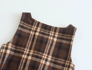Detailed view of the vintage plaid pattern and thick fabric on a retro sleeveless top