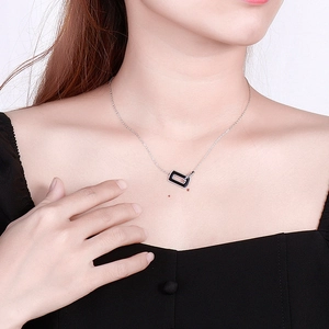 Minimalist silver square pendant necklace with black resin detail and thin chain