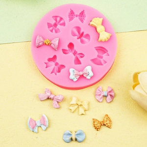 Pink silicone mold featuring nine bow designs for DIY cake fondant and resin crafts