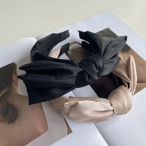 Elegant satin bow headband set in black and beige colors with pleated luxury silk texture