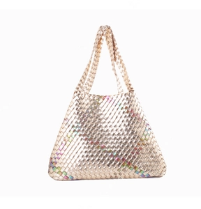 Detailed shot of rainbow metallic woven tote bag with shimmering champagne gold texture
