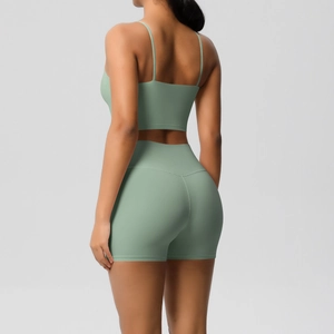 Back view of mint green yoga set showing cross straps and high-waisted fitness shorts