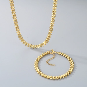 Detailed close-up of golden wheat link necklace and bracelet set with lobster clasp